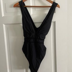 NWT. Never worn. One piece black swimsuit. Cross back. Front detail.